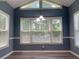 Bright dining room showcasing large windows, modern lighting, fresh paint, and new wood flooring at 4635 Tims Pl, Snellville, GA 30039