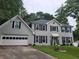 Charming two-story home with gray painted brick, black shutters, and a well-manicured lawn at 4635 Tims Pl, Snellville, GA 30039