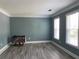 Living room featuring neutral walls, white trim, wood floors, and two windows for natural light at 4635 Tims Pl, Snellville, GA 30039