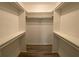 Walk-in closet features built-in shelving, closet rods, and new wood flooring for organized storage at 4635 Tims Pl, Snellville, GA 30039