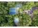 Aerial view of tennis courts and pool with parking surrounded by greenery at 1001 Braelin Ct, Woodstock, GA 30189