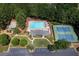 Aerial view of the community pool, tennis courts, a playground, and a clubhouse with parking at 1001 Braelin Ct, Woodstock, GA 30189