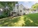 Spacious backyard featuring a wooden deck, lush greenery, and ample sunlight at 1001 Braelin Ct, Woodstock, GA 30189