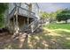 Backyard features a wooden deck with stairs leading down to a grassy area at 1001 Braelin Ct, Woodstock, GA 30189