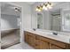 Bathroom with double sinks, and a view into the primary bedroom at 1001 Braelin Ct, Woodstock, GA 30189