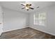 This light and airy bedroom offers wood flooring and a ceiling fan at 1001 Braelin Ct, Woodstock, GA 30189