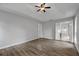 Open bedroom with hardwood floors, ceiling fan, and natural lighting at 1001 Braelin Ct, Woodstock, GA 30189
