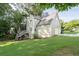 Exterior view of the home featuring a well-maintained lawn and a spacious wooden deck at 1001 Braelin Ct, Woodstock, GA 30189