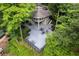 Exterior elevated view of a home with a large wraparound deck and forest surroundings at 1001 Braelin Ct, Woodstock, GA 30189