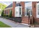 Close-up of a brick home's front entrance with bay windows and detailed landscaping at 1001 Braelin Ct, Woodstock, GA 30189