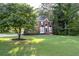 Beautiful brick home with manicured lawn, mature trees, and classic curb appeal at 1001 Braelin Ct, Woodstock, GA 30189