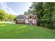 Attractive two-story brick home on a spacious lot with lush green lawn at 1001 Braelin Ct, Woodstock, GA 30189