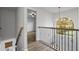 Upper hallway featuring stylish railing and decorative chandelier at 1001 Braelin Ct, Woodstock, GA 30189