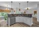 Bright kitchen featuring sleek countertops, stainless steel appliances and contemporary pendant lighting at 1001 Braelin Ct, Woodstock, GA 30189
