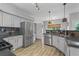 Updated kitchen with stainless steel appliances, stone countertops and stylish backsplash at 1001 Braelin Ct, Woodstock, GA 30189