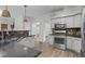 Well-designed kitchen with updated appliances, stone countertops and tile backsplash at 1001 Braelin Ct, Woodstock, GA 30189