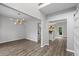 Open-concept living space with hardwood floors and modern lighting fixtures at 1001 Braelin Ct, Woodstock, GA 30189