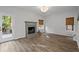 Inviting living room with a cozy fireplace, large windows, and access to the deck at 1001 Braelin Ct, Woodstock, GA 30189
