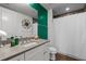 Bathroom features a white vanity, an ornate mirror, an emerald green accent wall and a shower with curtain at 270 17Th Nw St # 2804, Atlanta, GA 30363