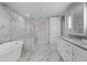 Bright bathroom features marble tiling, a freestanding tub, glass-enclosed shower, and a double sink vanity at 270 17Th Nw St # 2804, Atlanta, GA 30363