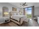 Bright bedroom features a decorative mirror, ceiling fan, and an expansive window showing off the city views at 270 17Th Nw St # 2804, Atlanta, GA 30363