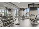 Modern gym with free weights, cable machines, mirrors, and windows with a city view at 270 17Th Nw St # 2804, Atlanta, GA 30363