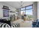 Home office with a large window, floating shelves, modern lighting, and a comfortable striped sofa at 270 17Th Nw St # 2804, Atlanta, GA 30363