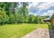 Spacious backyard featuring a brick patio and lush lawn at 3219 W Manor Ln, Atlanta, GA 30311