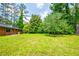 Spacious backyard with a well-maintained lawn and a brick house, perfect for outdoor enjoyment and entertaining at 3219 W Manor Ln, Atlanta, GA 30311