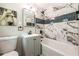 Modern bathroom with marble tile surround, vanity, and sleek fixtures at 3219 W Manor Ln, Atlanta, GA 30311