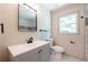 Bathroom featuring a modern vanity, new toilet, and stylish mirror at 3219 W Manor Ln, Atlanta, GA 30311