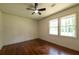 Bright bedroom featuring hardwood floors, neutral walls, and a ceiling fan with light at 3219 W Manor Ln, Atlanta, GA 30311