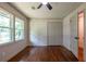 Bedroom with hardwood floors, closet, two large windows, and a ceiling fan at 3219 W Manor Ln, Atlanta, GA 30311