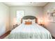 Comfortable bedroom with hardwood floors, decorative pillows, and accent lamps on side tables at 3219 W Manor Ln, Atlanta, GA 30311