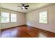 Bright bedroom with hardwood floors, large windows, and a ceiling fan at 3219 W Manor Ln, Atlanta, GA 30311