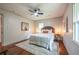 Relaxing bedroom with hardwood floors, ceiling fan, decorative artwork, and lots of light at 3219 W Manor Ln, Atlanta, GA 30311