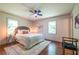 Cozy bedroom with hardwood floors, area rug, ceiling fan, and ample natural light at 3219 W Manor Ln, Atlanta, GA 30311