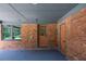 Covered carport adjacent to a brick home with doorways, offering shelter and convenience at 3219 W Manor Ln, Atlanta, GA 30311