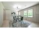 Dining area with natural light, a glass table, modern lighting, and stylish decor at 3219 W Manor Ln, Atlanta, GA 30311