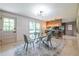 Dining room featuring a glass table, chandelier, and an open layout to the kitchen at 3219 W Manor Ln, Atlanta, GA 30311