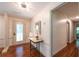 Inviting foyer with hardwood floors, stylish console table, and decorative mirror at 3219 W Manor Ln, Atlanta, GA 30311