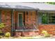 Brick home with a covered front porch, featuring gray trim and a concrete walkway at 3219 W Manor Ln, Atlanta, GA 30311