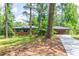 Inviting brick home boasts lush front lawn, mature trees, and a paved driveway at 3219 W Manor Ln, Atlanta, GA 30311