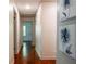 Bright hallway featuring hardwood floors and elegant floral artwork on the wall at 3219 W Manor Ln, Atlanta, GA 30311