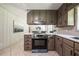Charming kitchen with stainless steel oven, light countertops, and view into dining room at 3219 W Manor Ln, Atlanta, GA 30311