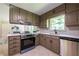Bright kitchen with stainless appliances, white subway backsplash, and view to dining area at 3219 W Manor Ln, Atlanta, GA 30311