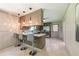 A kitchen bar area with stainless steel appliances, quartz countertop, and stylish pendant lighting at 3219 W Manor Ln, Atlanta, GA 30311