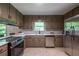 Kitchen features a stainless steel refrigerator and modern appliances with a window view at 3219 W Manor Ln, Atlanta, GA 30311