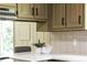 A kitchen counter with lots of counter space, neutral backsplash, and great lighting at 3219 W Manor Ln, Atlanta, GA 30311