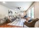 Inviting living room with natural light, comfortable seating, and hardwood floors at 3219 W Manor Ln, Atlanta, GA 30311